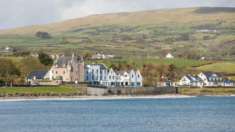 Coastal hotel with charming cottages and scenic hills, offering peaceful stays near the sea in lush countryside.
